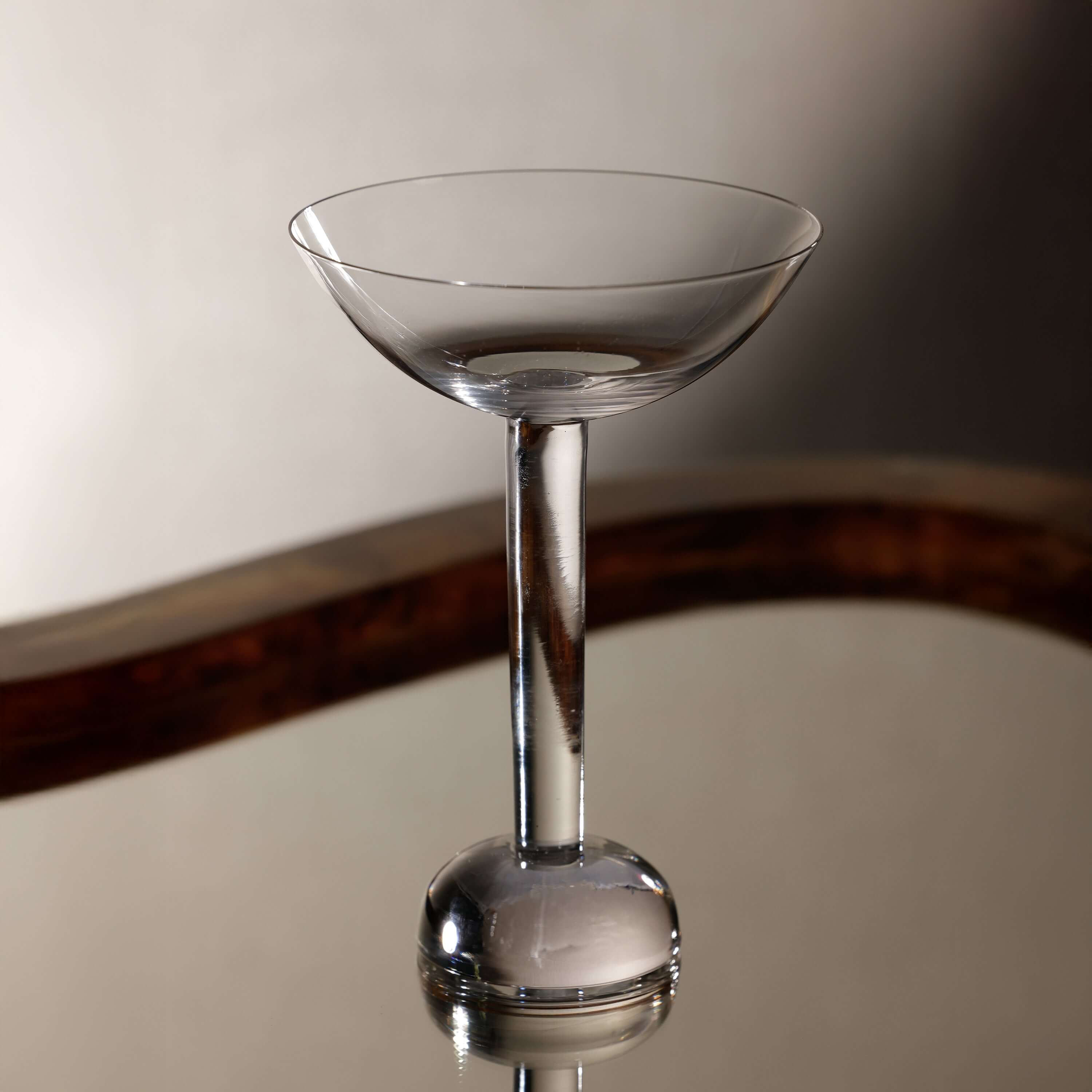 Elegant cocktail glass from the Madrid Glassware Collection showcasing a sculptural sphere base.