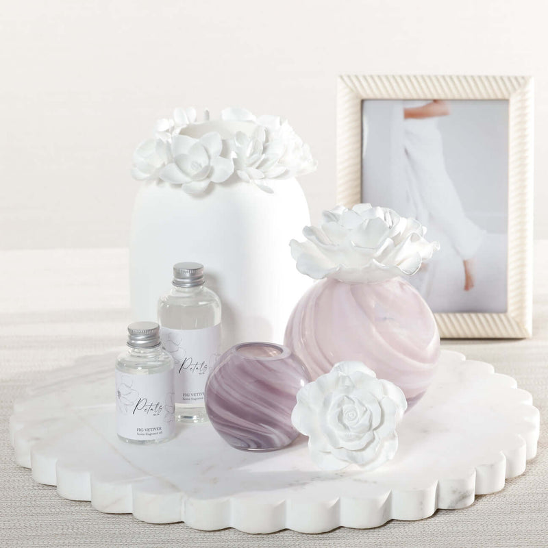 Petals Porcelain Diffuser - Small displayed with marbled glass and delicate porcelain flowers on a marble tray.