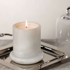 Marbella Scented Candle Jar with Cloche on a silver tray, featuring a flickering flame and elegant design.