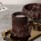 Marbella Scented Candle Jar with Cloche displayed on a gold tray, showcasing its unique marble design.