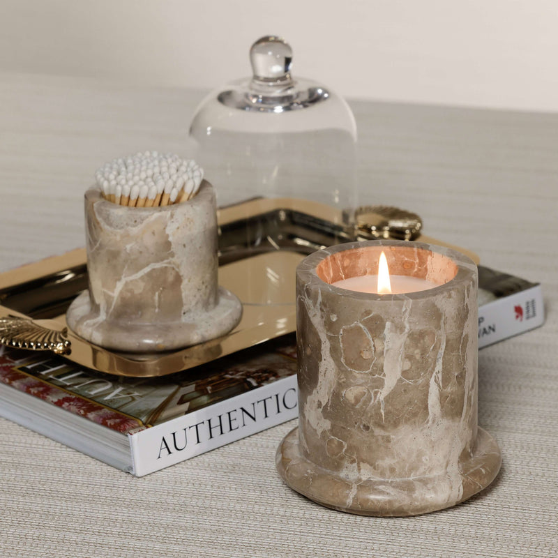 Marbella Scented Candle Jar with Cloche displayed on a tray beside a cotton swab holder and a magazine.