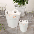 Citronella Pot Candle displayed in white ceramic pots, ideal for outdoor settings and adding elegance.