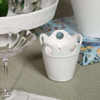 Stylish Citronella Pot Candle in white ceramic, featuring a scalloped rim and decorative cut-outs.