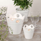 Citronella Pot Candle in white ceramic with scalloped rim and decorative cut-outs, ideal for outdoor use.
