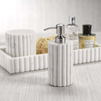 Camogli Bath Collection soap dispenser featuring solid white marble with sculpted vertical fluting.