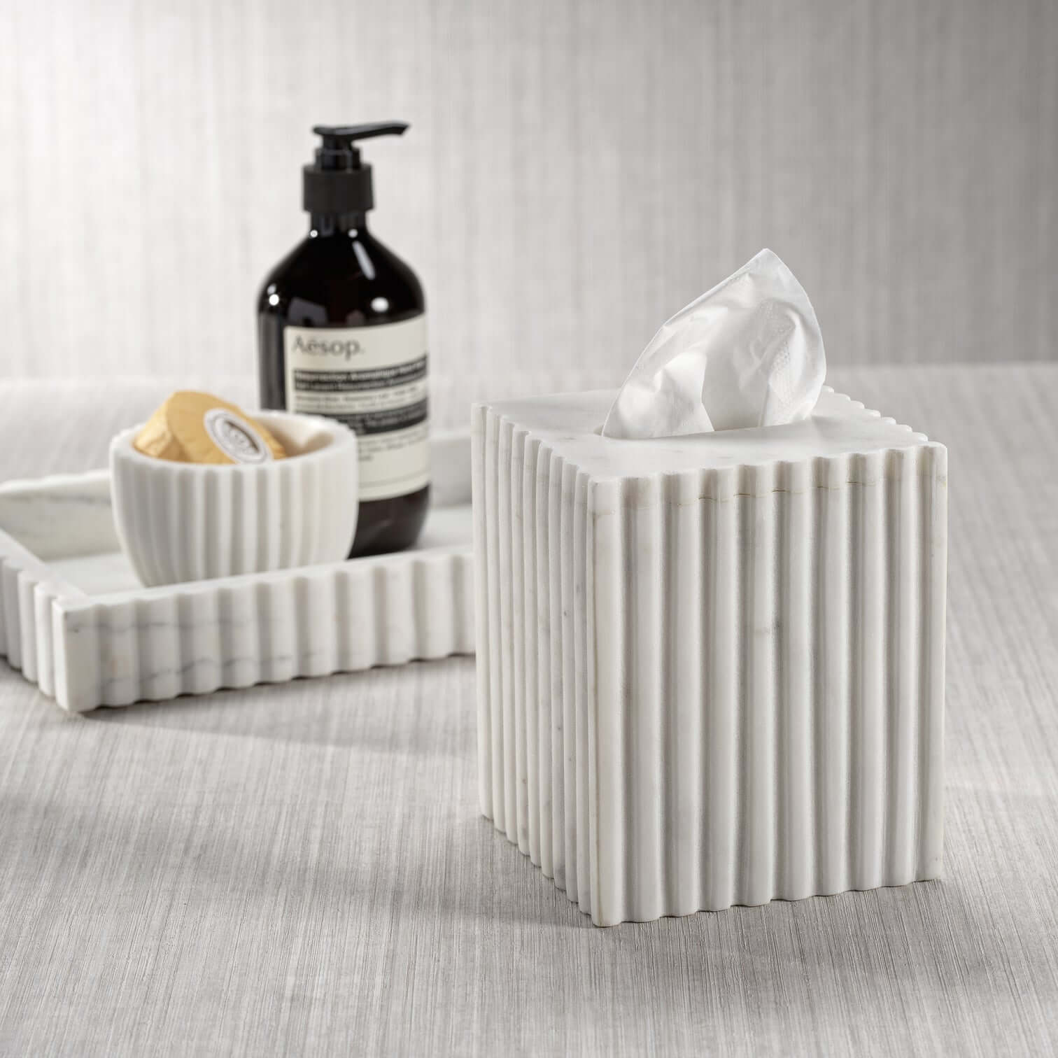 Tissue box from the Camogli Bath Collection, crafted in solid white marble with vertical fluting for a sculptural look.