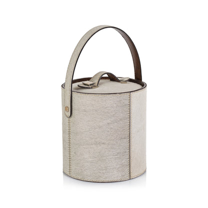 Textured cylindrical container with a handle on a white background
