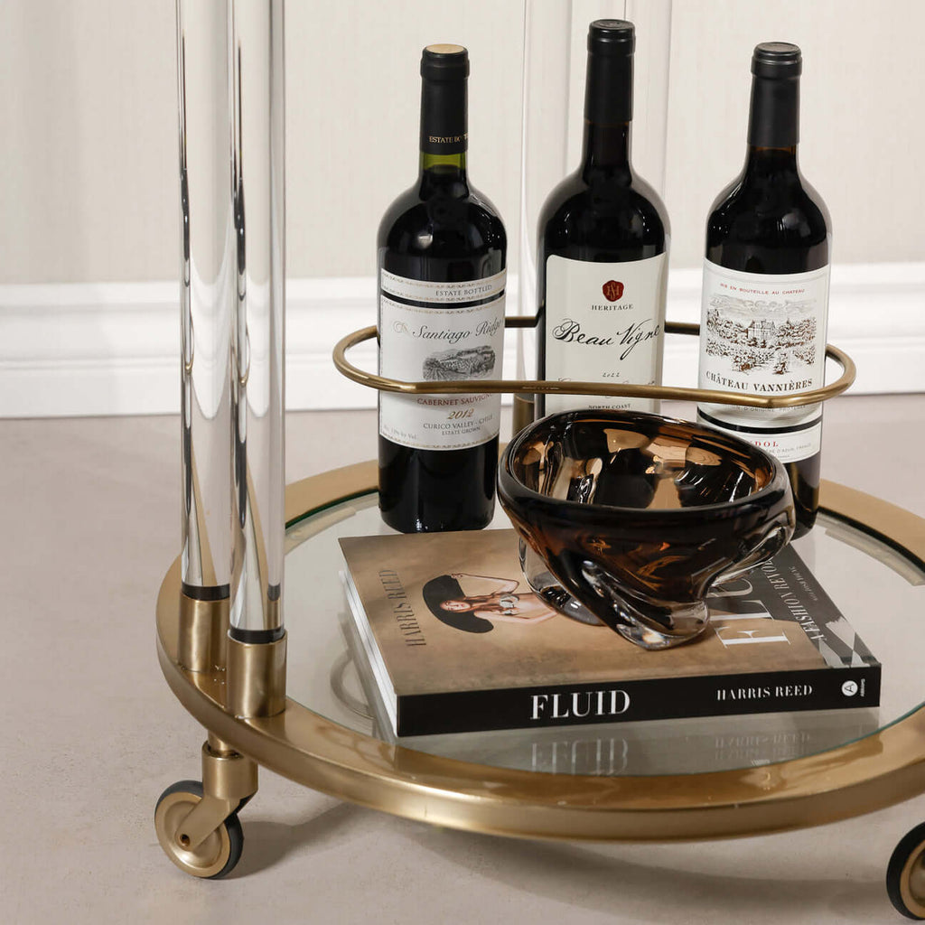 Opus Round Bar Cart / Trolley - Small with wine bottles and decorative bowl on mirrored glass surface.