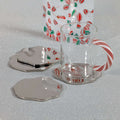 Clear glass mug with candy cane design on a white surface