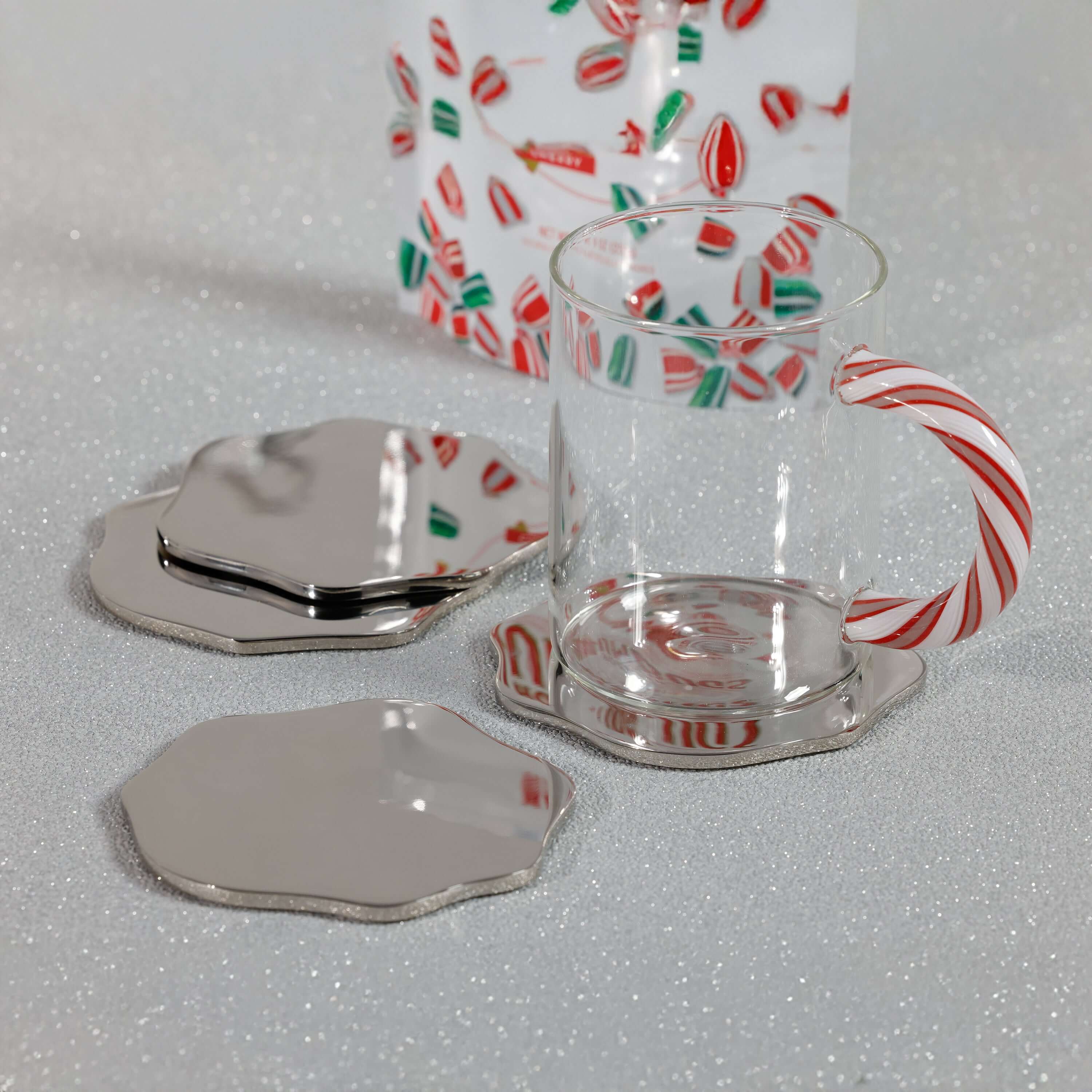 Clear glass mug with candy cane design on a white surface