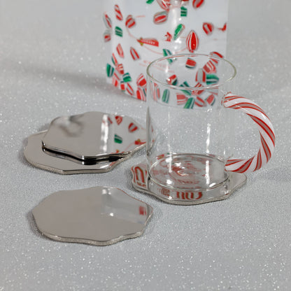 Clear glass mug with candy cane design on a white surface