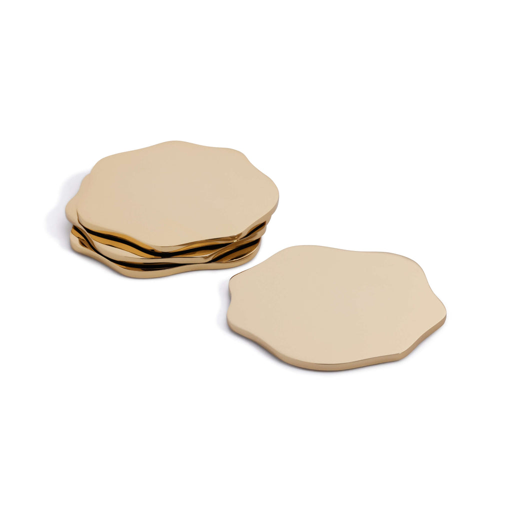 Set of gold hexagonal coasters on a white background