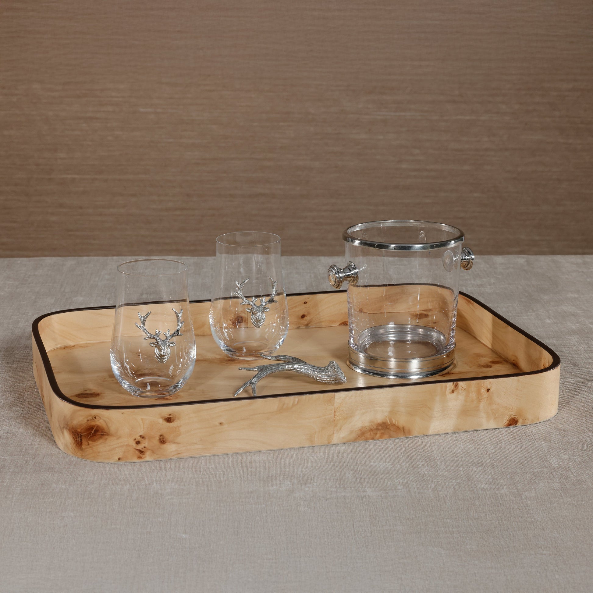 Wooden tray with glassware featuring deer designs on a neutral background