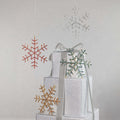 Decorative snowflake ornaments on a gray background