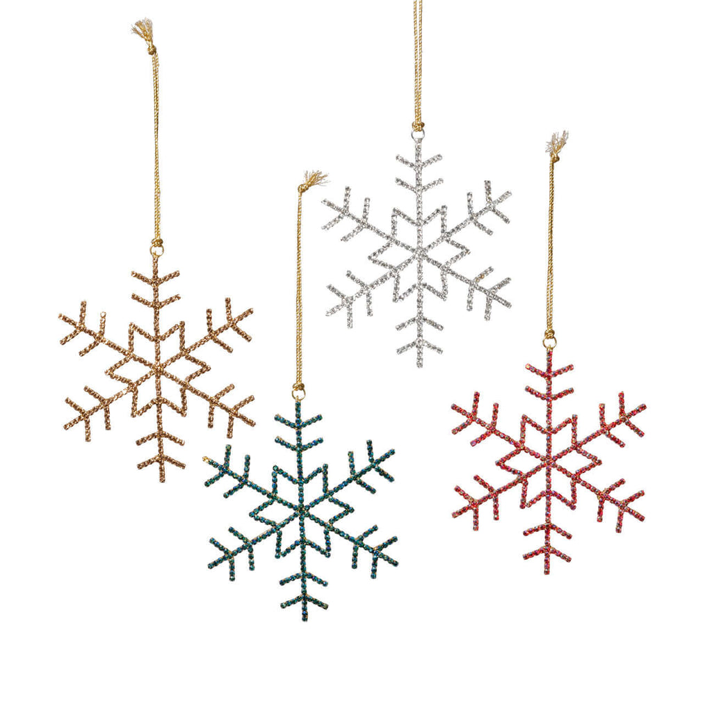 Set of four snowflake-shaped Christmas ornaments in gold, silver, green, and red on a white background.