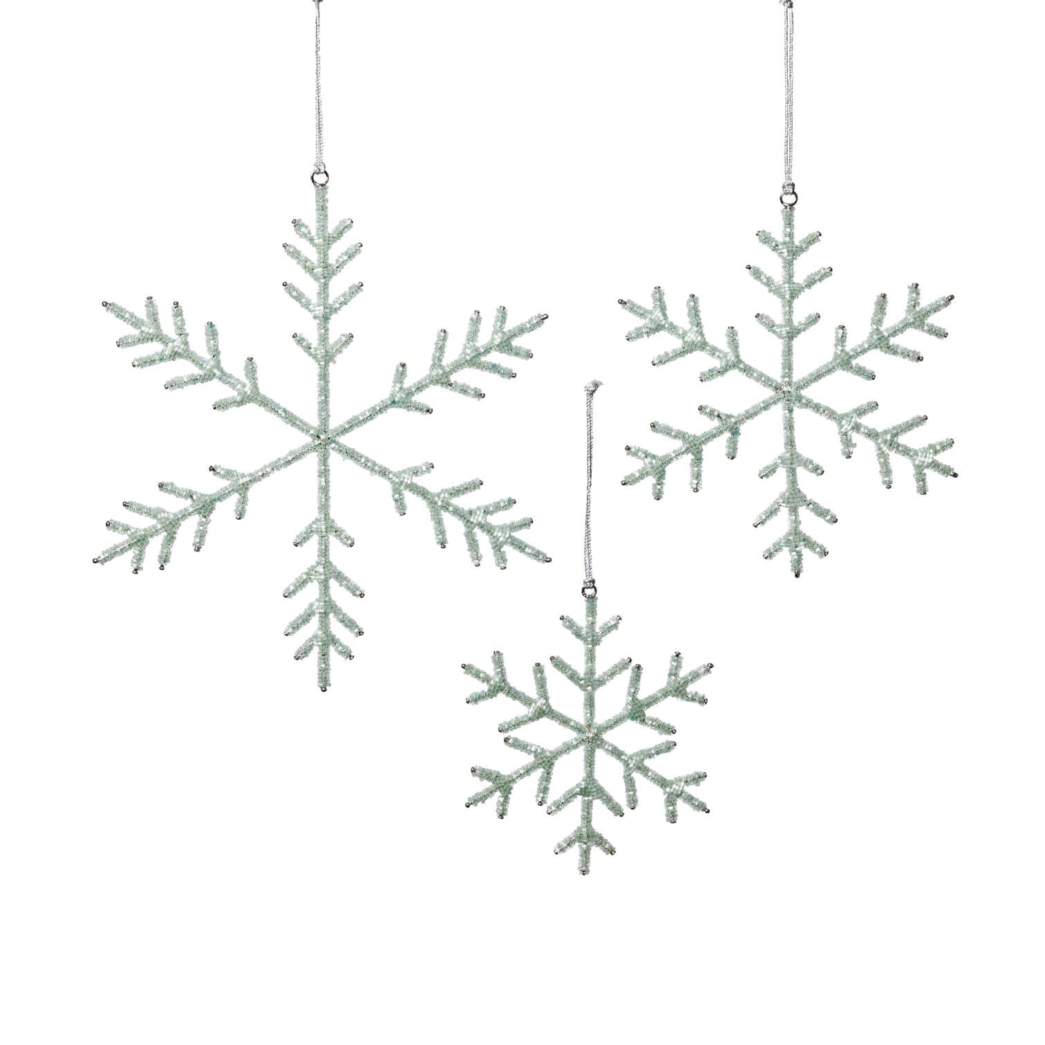 Three snowflake-shaped decorations hanging against a white background