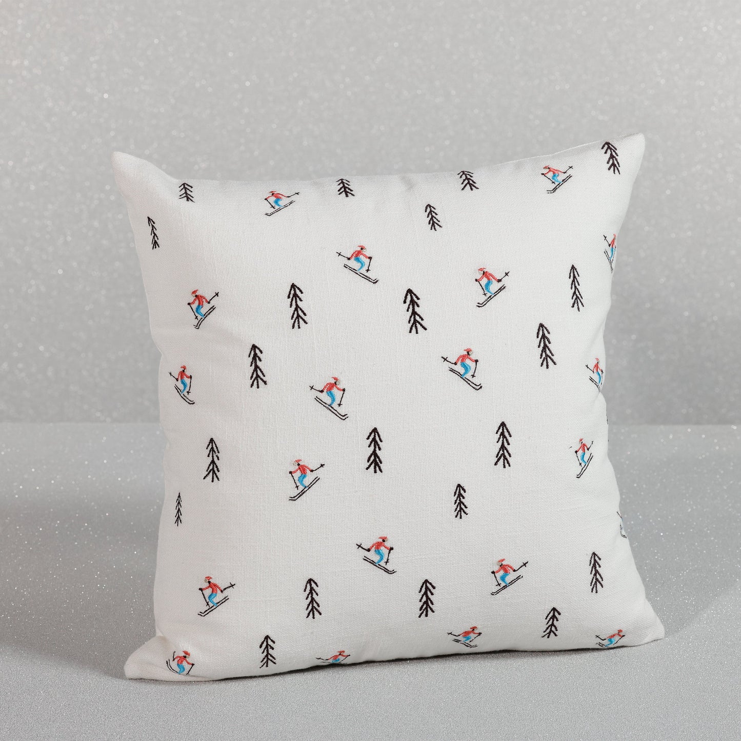 Decorative pillow with skiing pattern on a gray background
