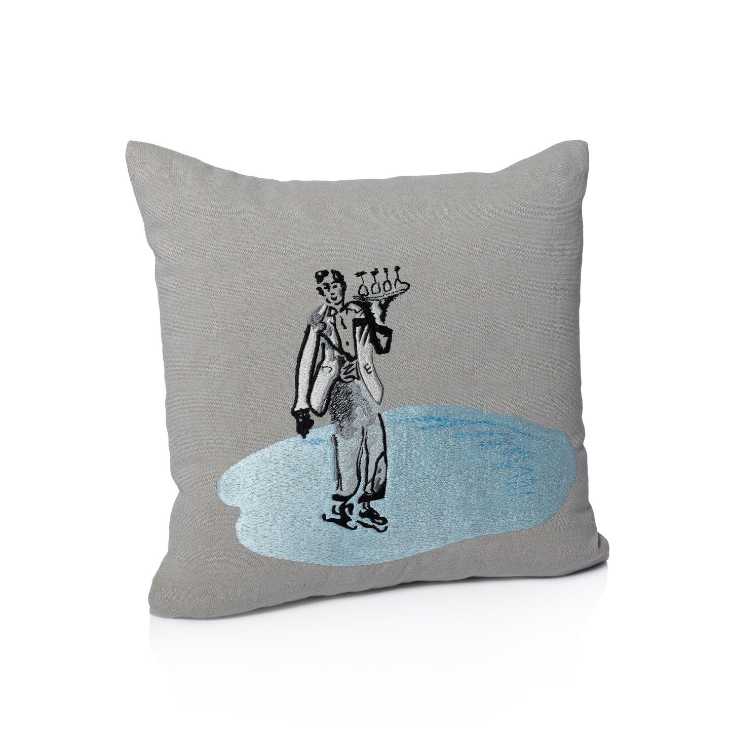Gray pillow with a decorative design of a person holding a globe on a white background