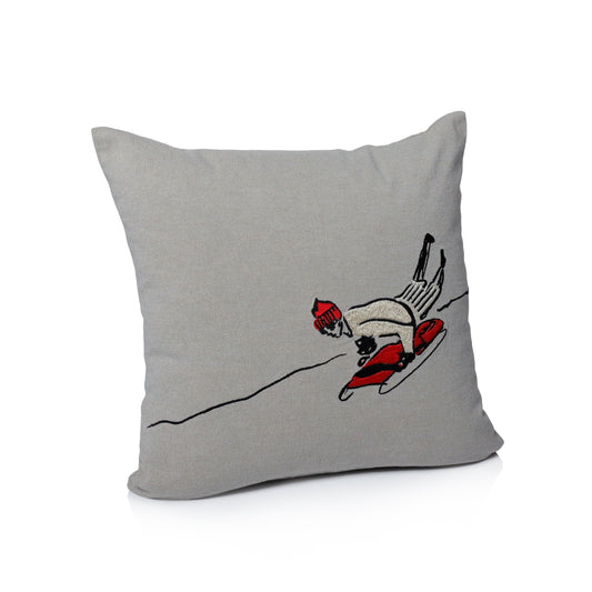 Gray pillow with a skier design on a white background