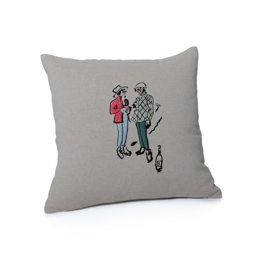 Gray pillow with a cartoon illustration of two people and a bottle on a white background
