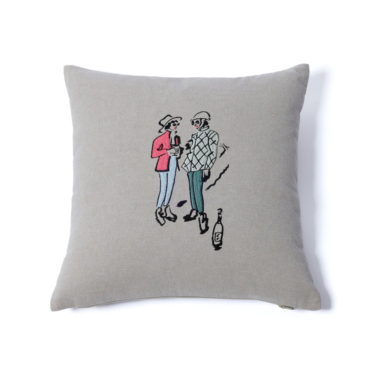 Gray pillow with embroidered design of two people and a bottle on a white background