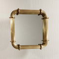 Limoges Ribbed Wall Mirror with ribbed brass frame and circular ring fittings.