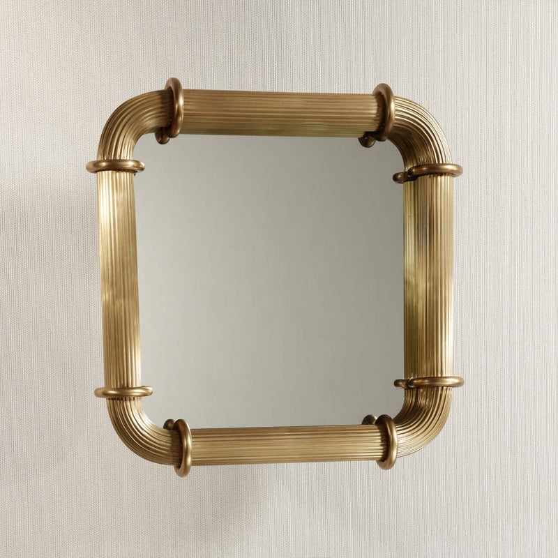 Limoges Ribbed Wall Mirror with ribbed brass frame and circular ring fittings.