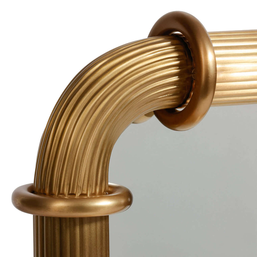 Close-up of the Limoges Ribbed Wall Mirror showcasing the ribbed brass-finish frame and circular ring fittings.