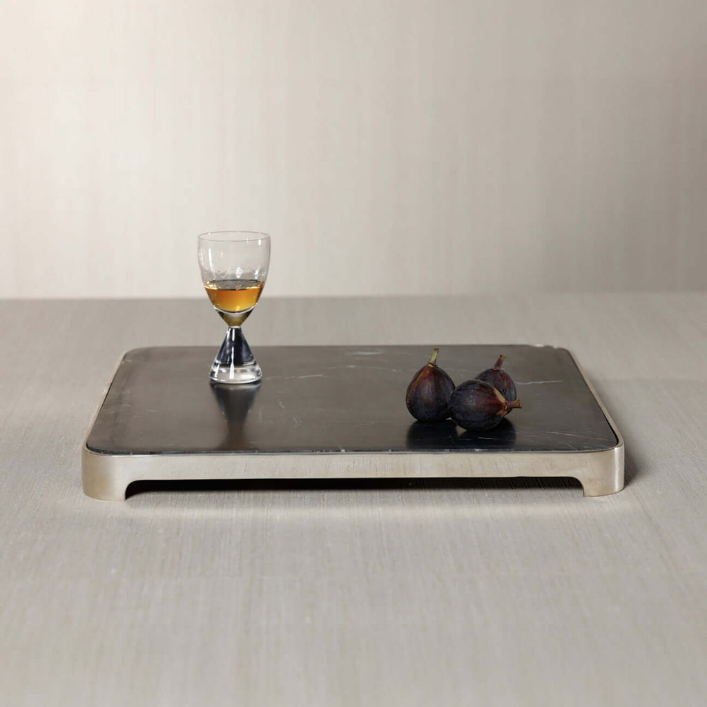 London Cheese and Charcuterie Marble Serving Tray with a glass and figs on a sleek black marble surface
