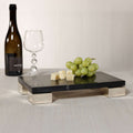 Roku Cheese and Charcuterie Marble Serving Tray featuring black marble, stainless steel feet, cheese, and grapes.
