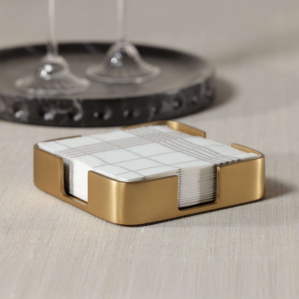 Gold Cocktail Napkin Holder featuring a satin brushed gold finish and geometric design with napkins inside.