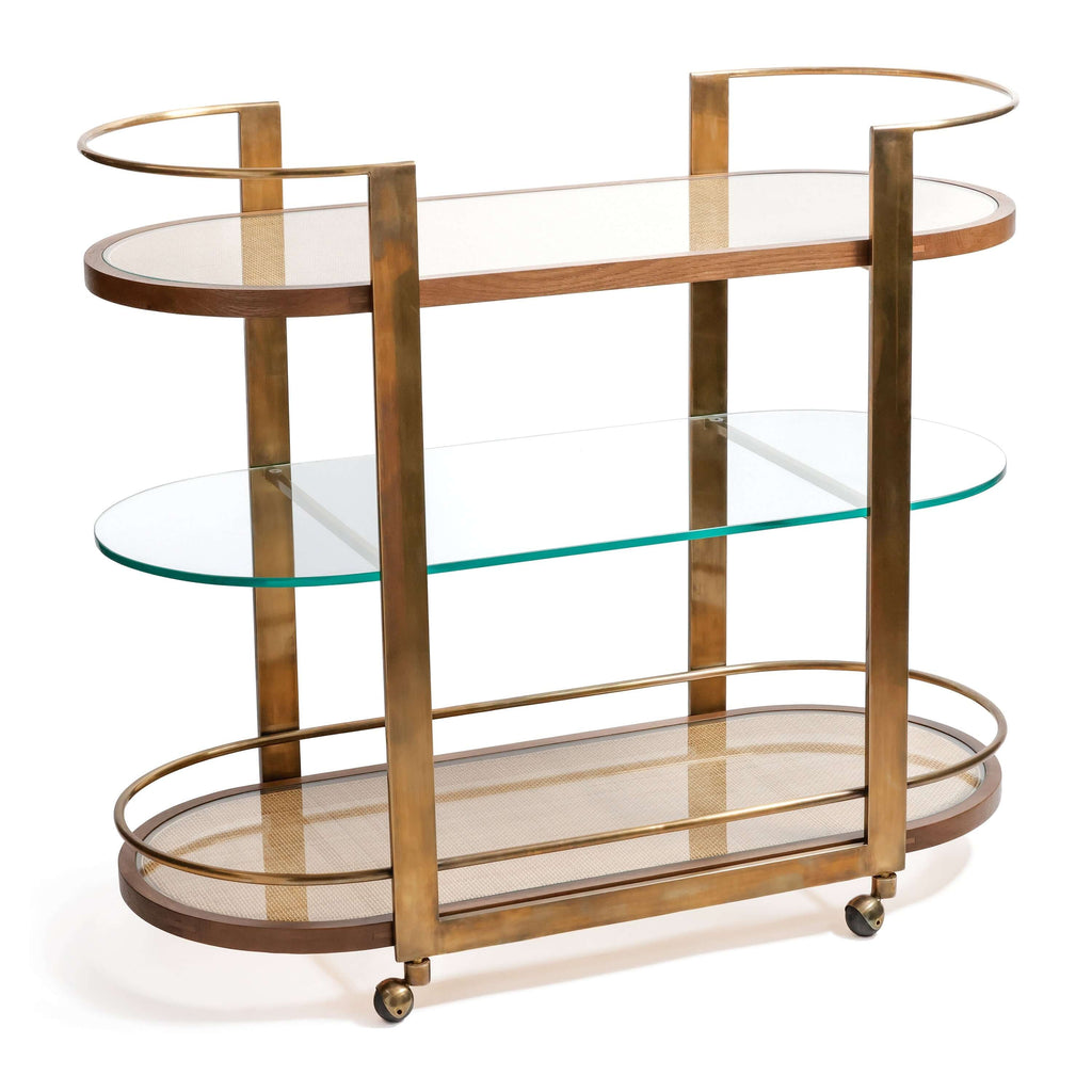 Sloane Oak Wood Oval Bar Cart featuring antique brass finished steel frame and glass shelves.