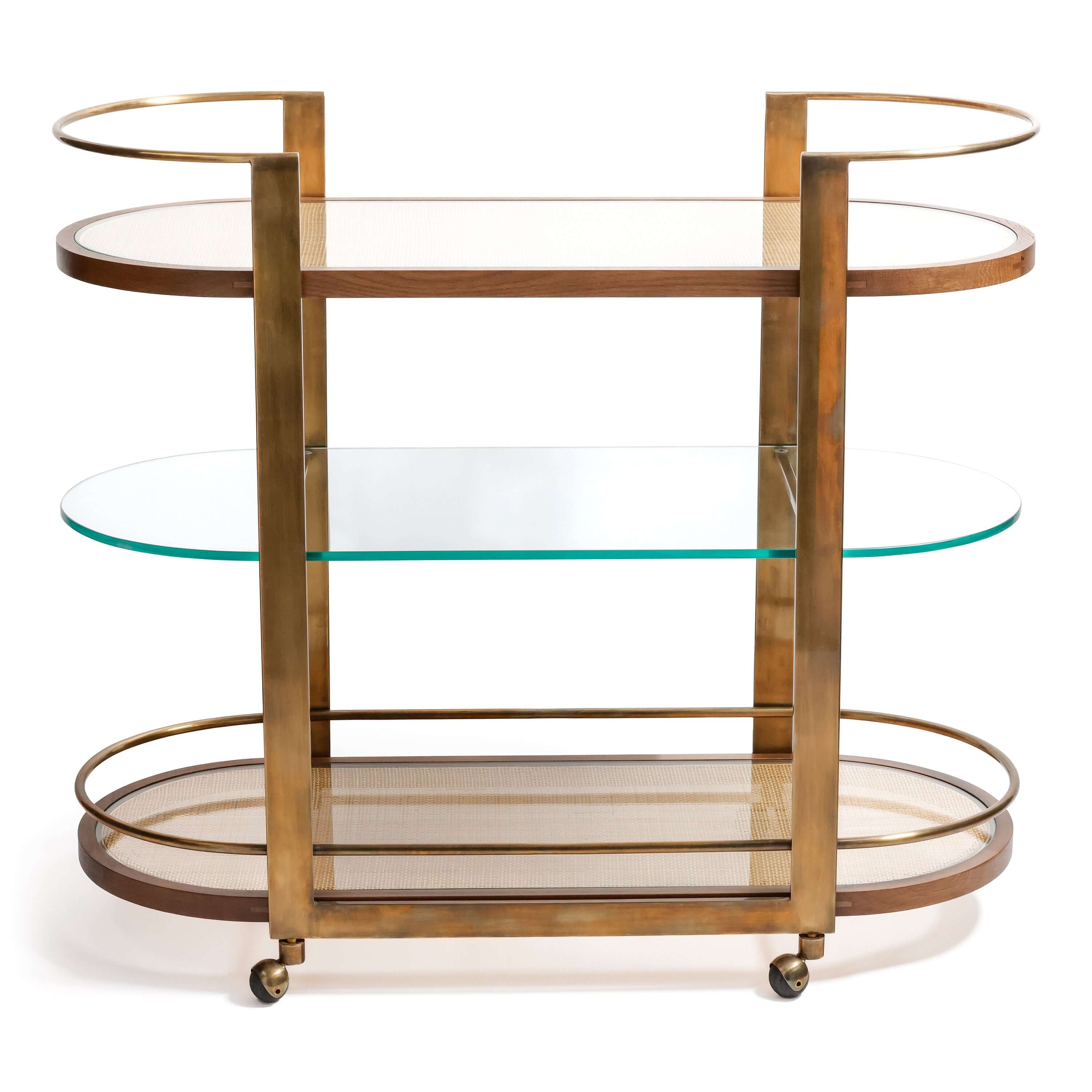 Sloane Oak Wood Oval Bar Cart featuring antique brass frame and glass shelves.