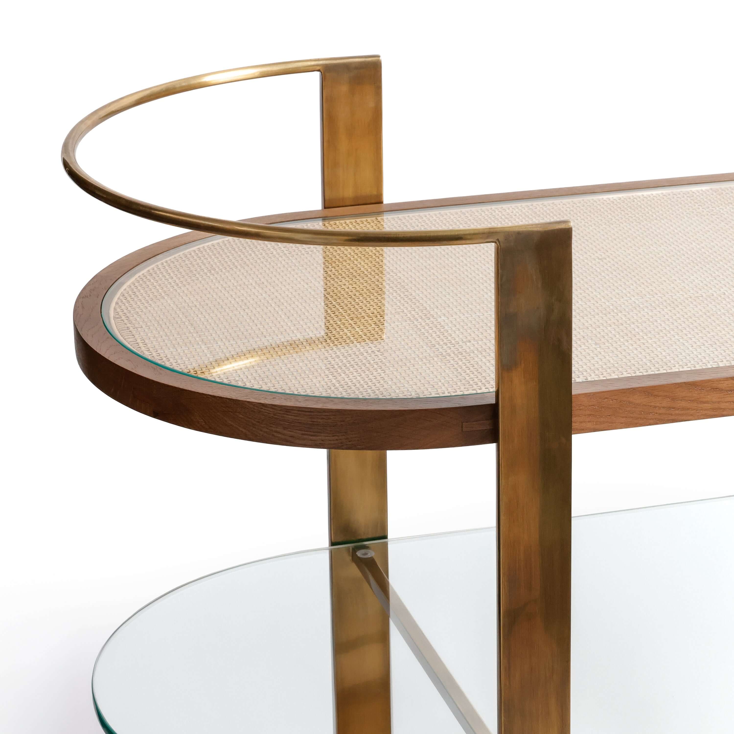 Sloane Oak Wood Oval Bar Cart featuring antique brass frame and clear glass surface.