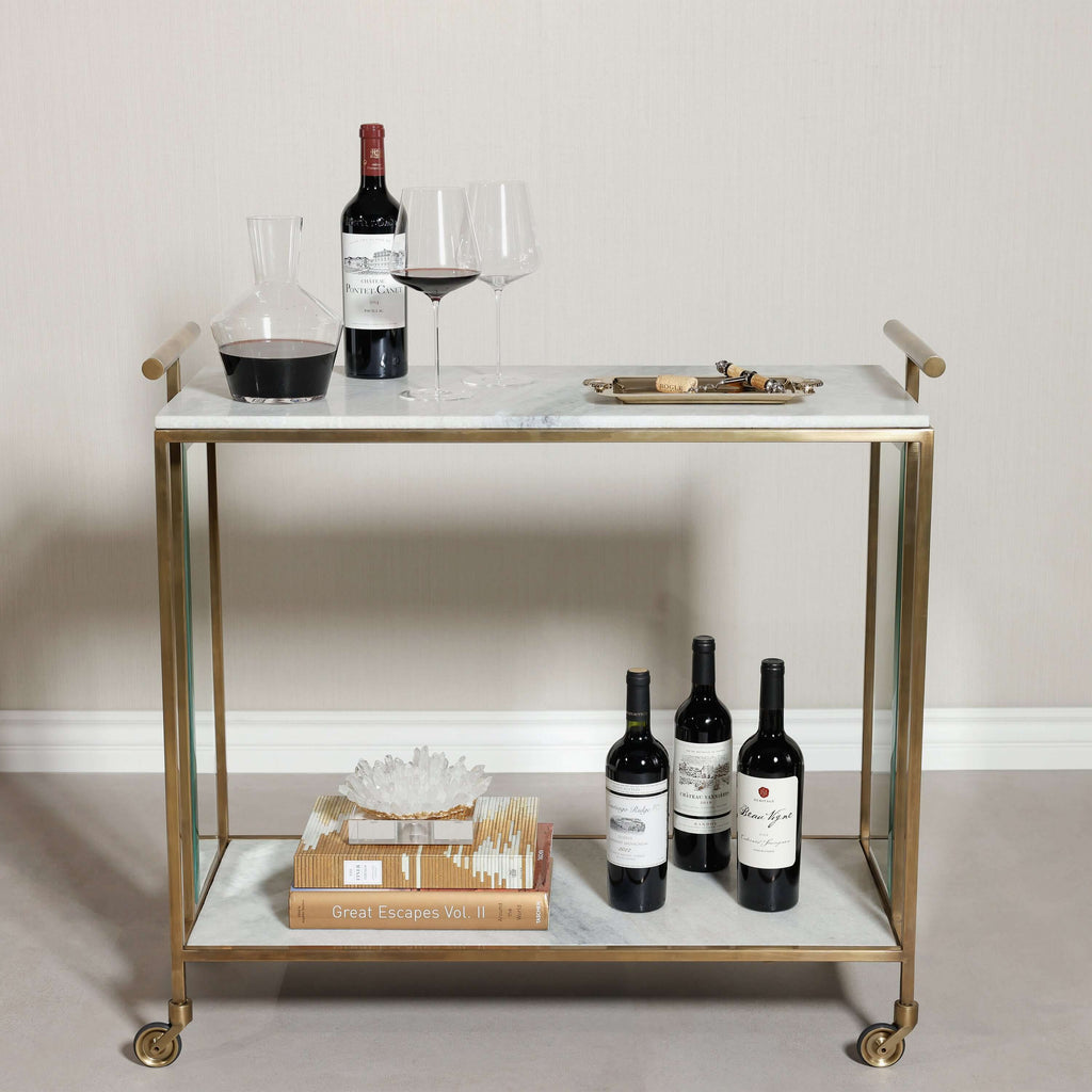 Soho Marble Bar Cart with brass frame, wine glasses, wine bottles, and decanter on marble top.