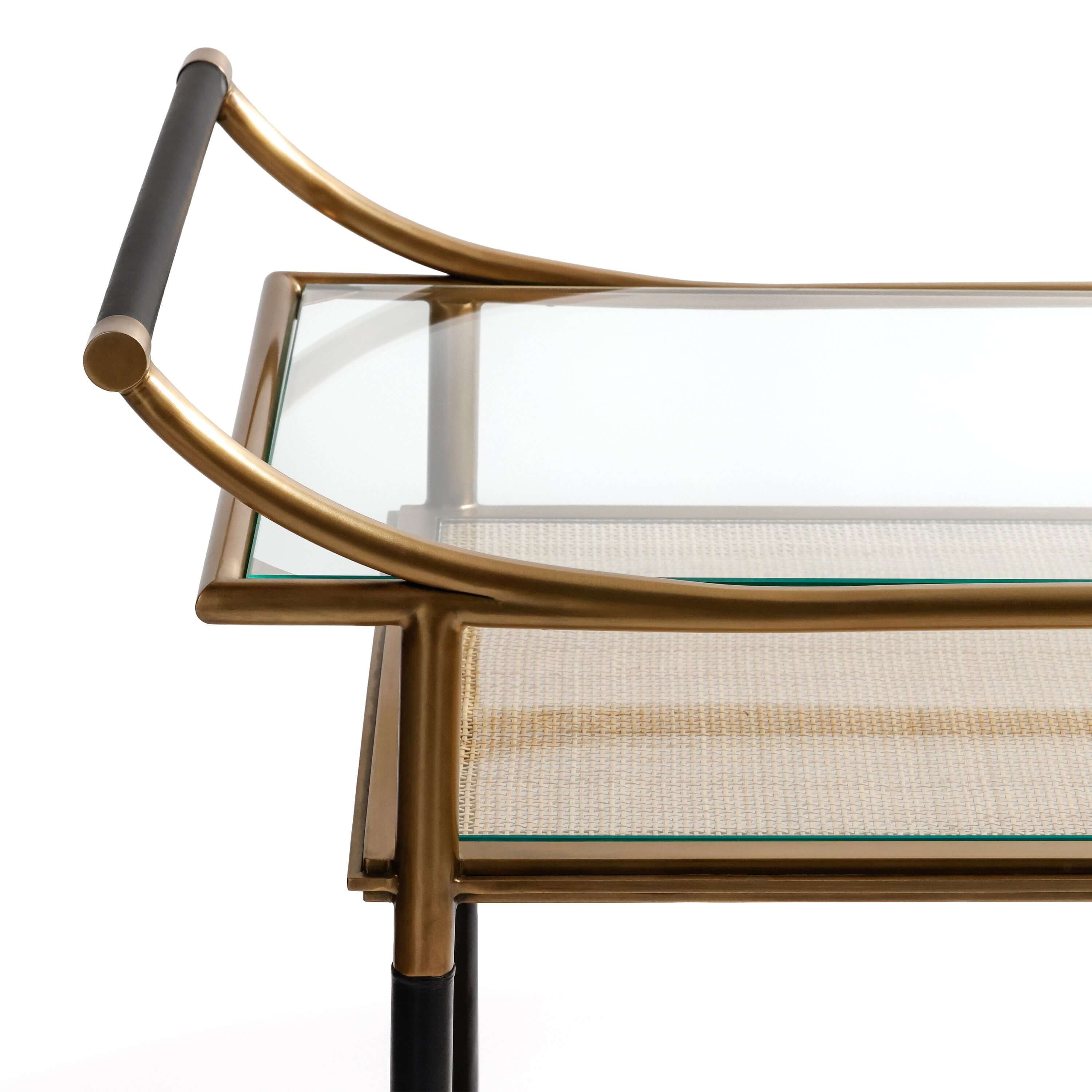 Mayfair 59 Bar Cart featuring antique brass steel frame and glass tabletop with woven texture.