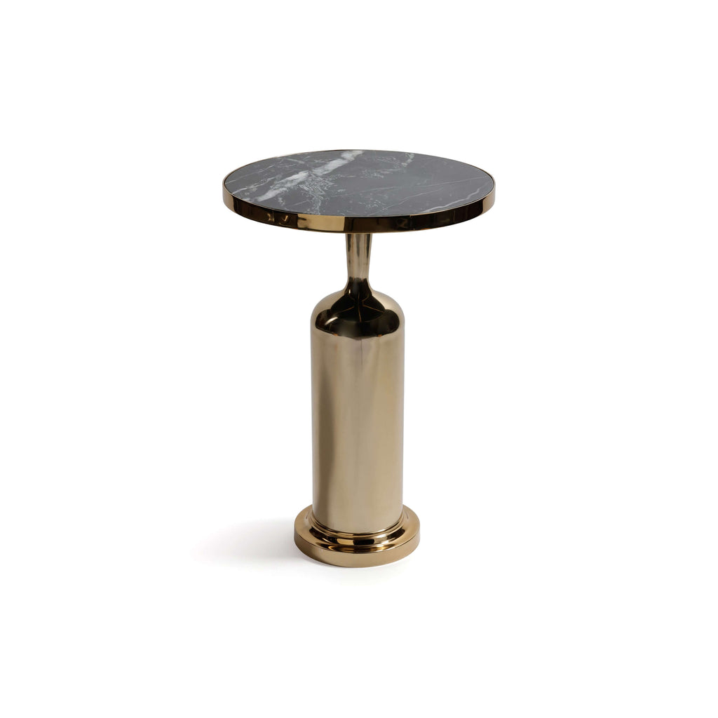 Nomad Table featuring a thick round nero marquina marble top and a polished gold rim on a brass pedestal base.