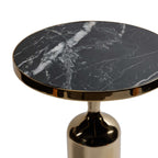 Close-up of the Nomad Table featuring a nero marquina marble top and polished gold trim.