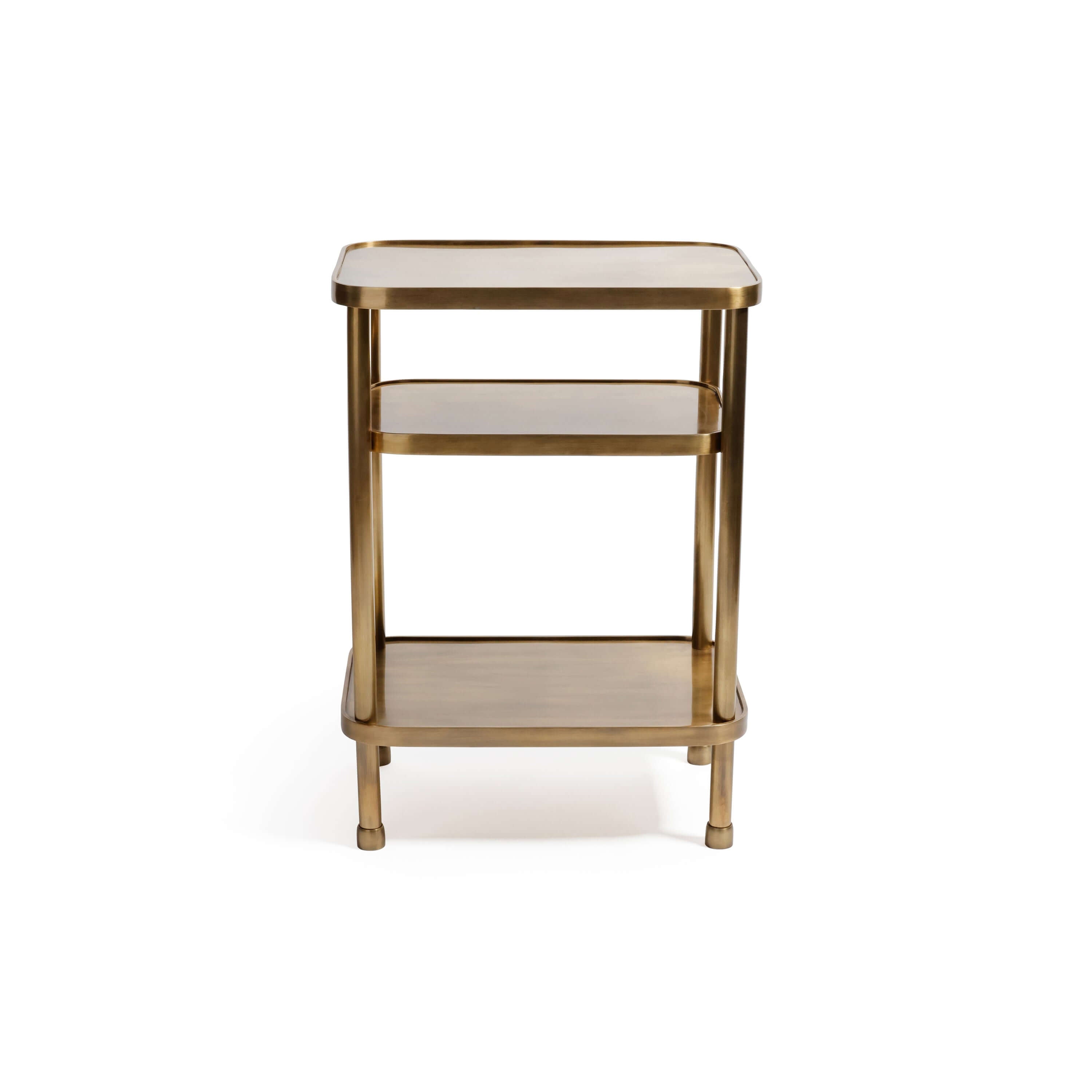 Aman Étagère, a three-tier open shelving table in warm antique brass, featuring rounded corners and cylindrical posts.