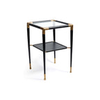 Peninsula Leather Side Table with brass joints and glass top, featuring a two-tier design and matte black finish.