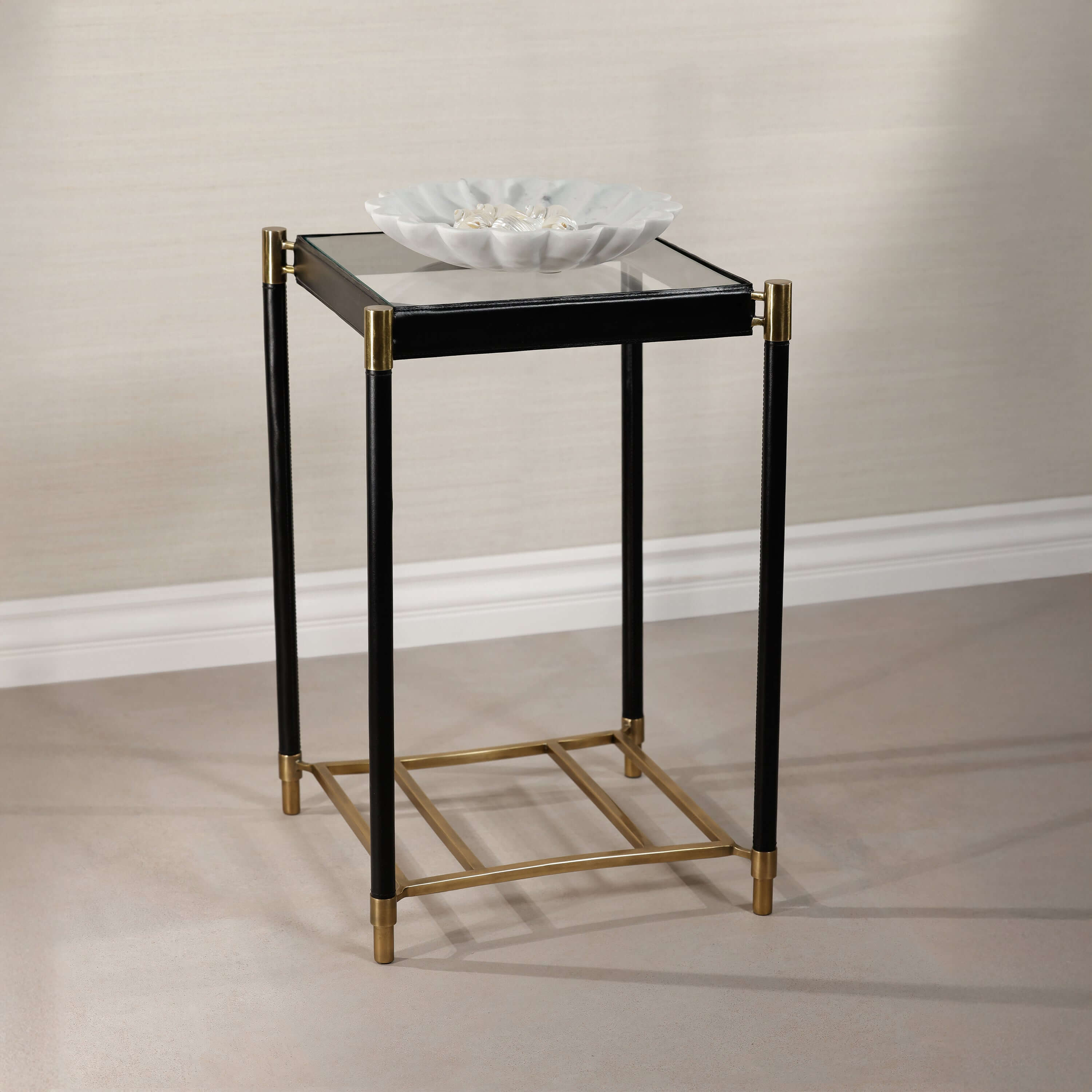 Park Lane 18 Leather Side Table with glass top, black leather legs, and brass accents, perfect for modern decor.
