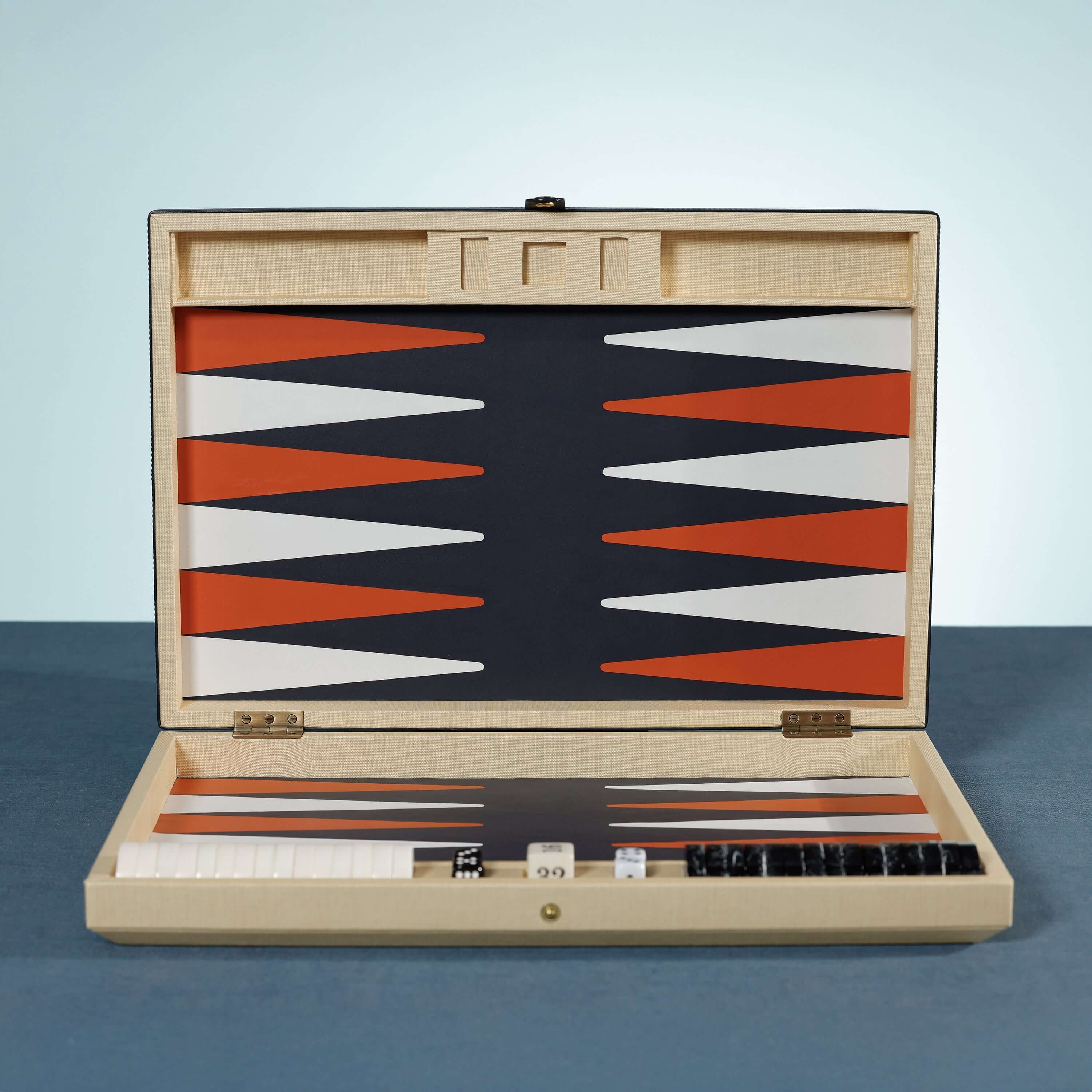 Monaco 19" Backgammon Set with burnt orange and white points on a deep graphite background, woven raffia case.