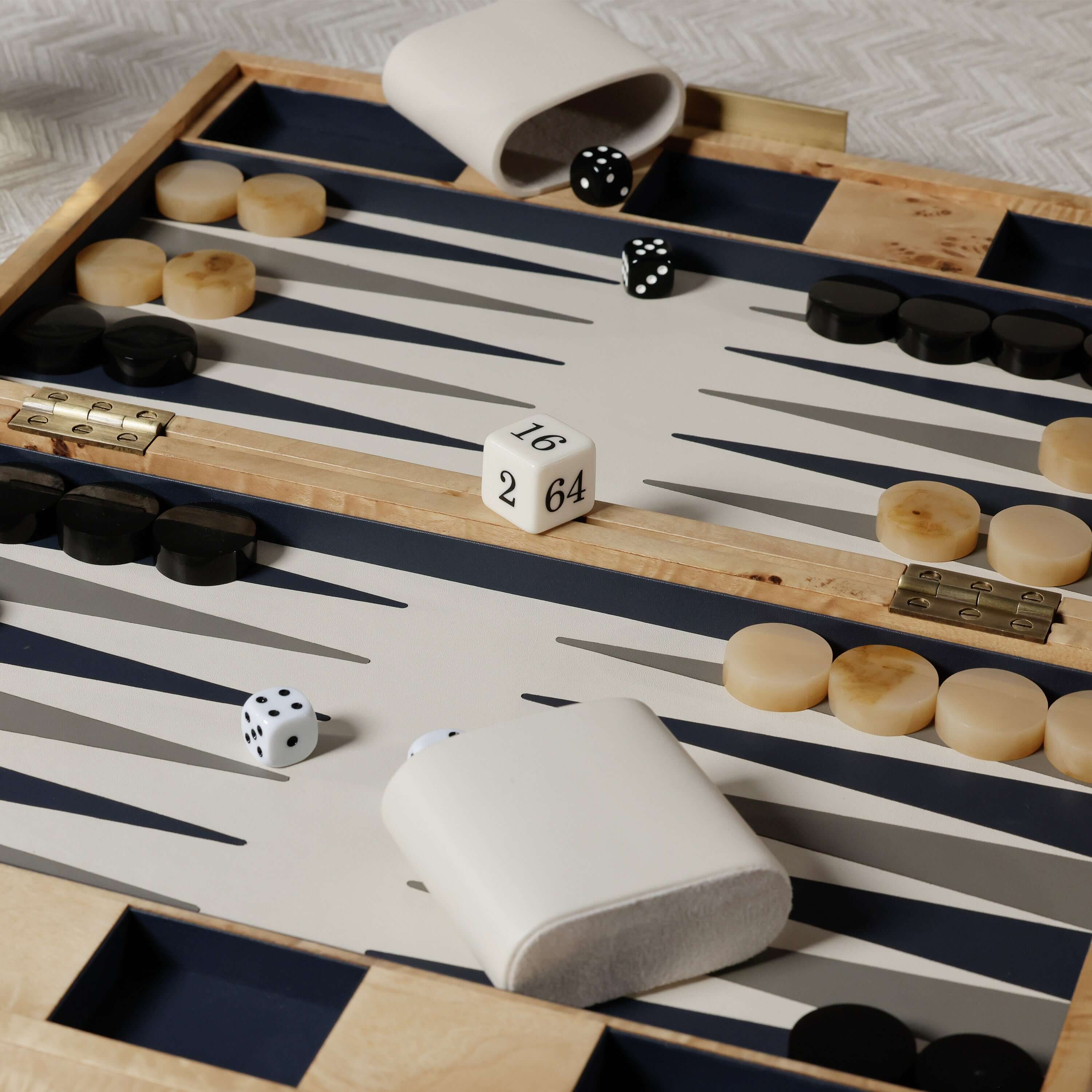 Marbella Backgammon Set with burl wood veneer, chic design, dice, and game pieces on a stylish board.