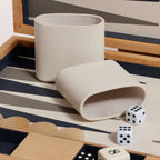 Marbella Backgammon Set featuring beige dice cups and dice on a stylish game board.