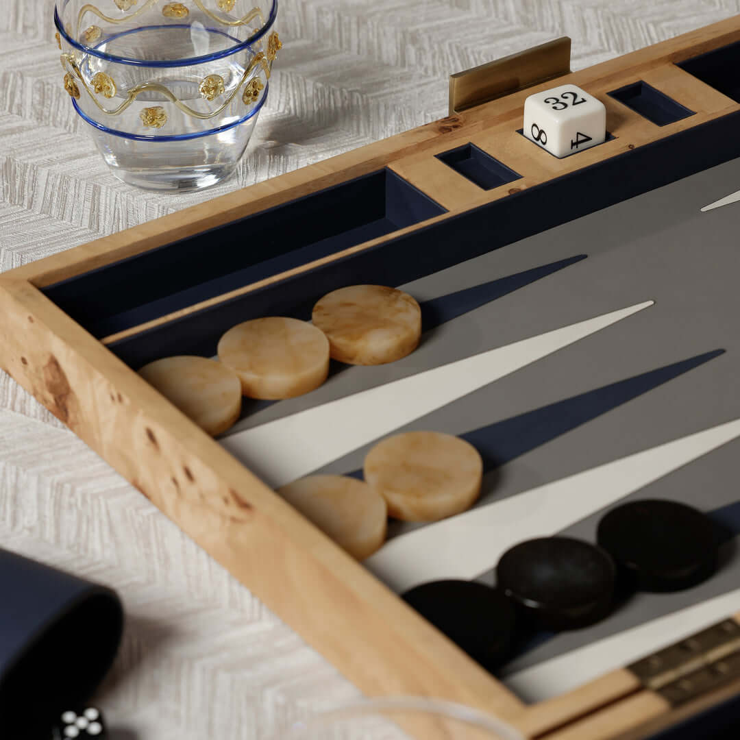 Close-up of Marbella Backgammon Set featuring burl wood case, game pieces, and dice.