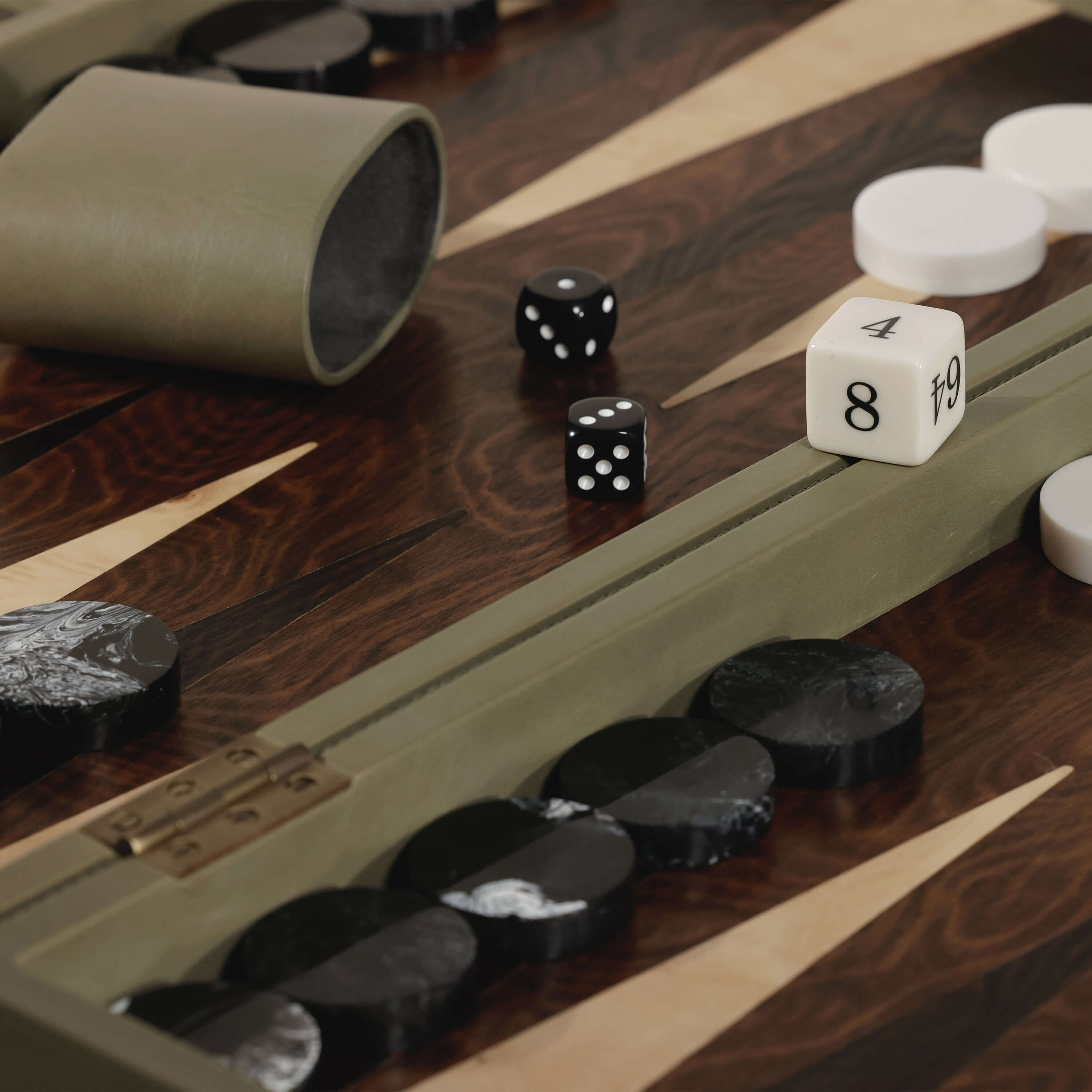 Geneva 19" Backgammon Set - Dusty Green Leather with game pieces and dice on a luxury wooden board.