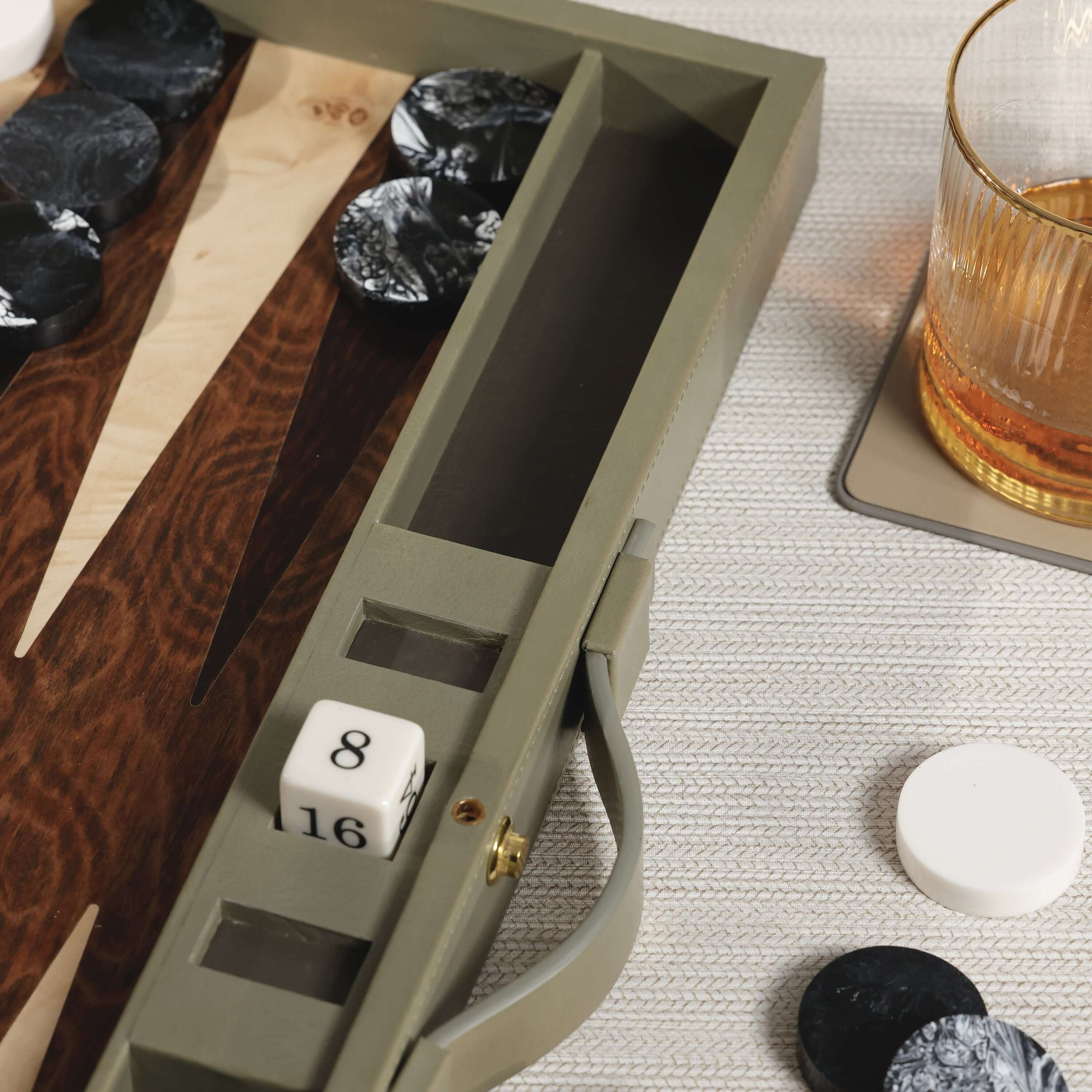 Close-up of Geneva 19" Backgammon Set - Dusty Green Leather with dice and game pieces.