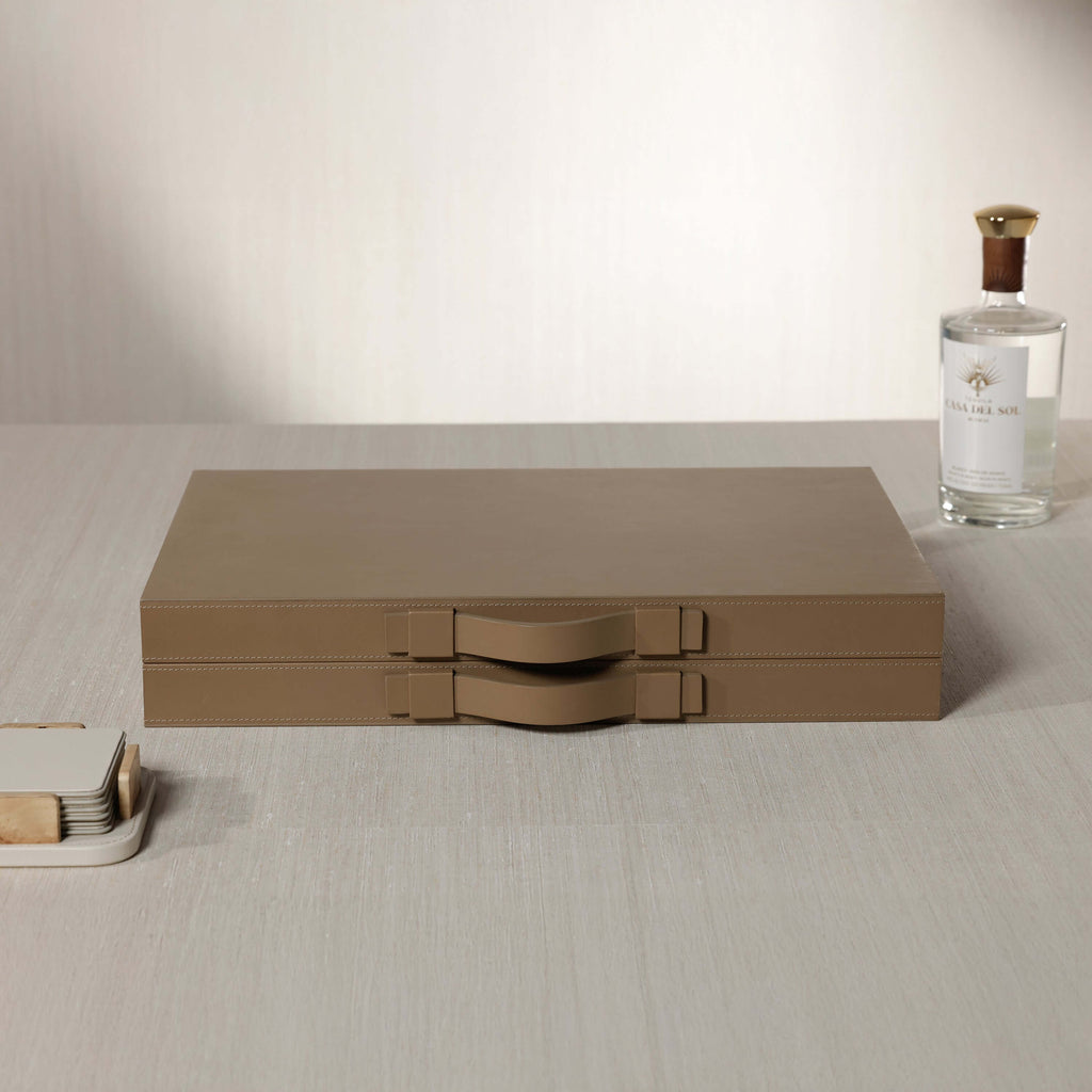 Geneva 19" Backgammon Set - Taupe Leather case with handles on a wooden table.