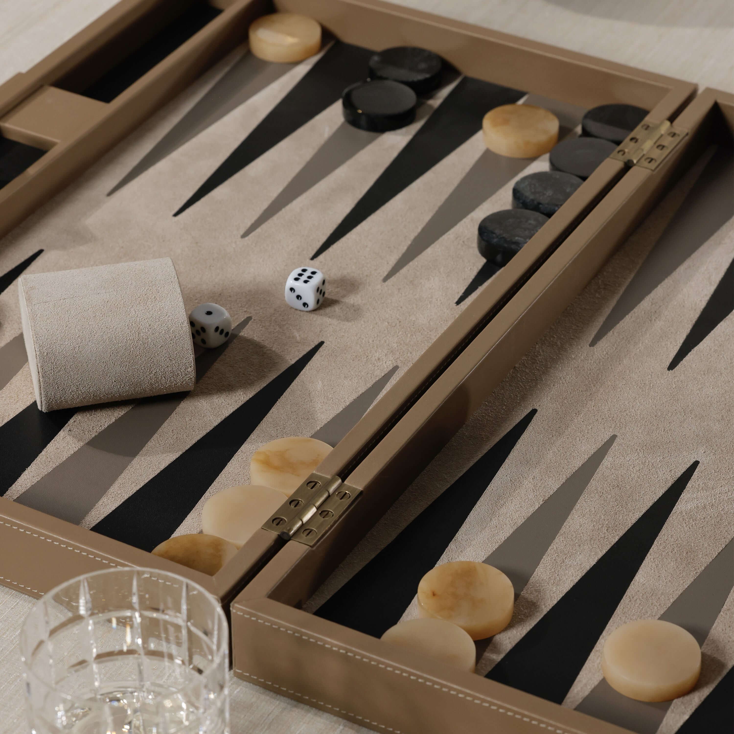 Geneva 19" Backgammon Set - Taupe Leather game board with dice and pieces on a smooth surface.
