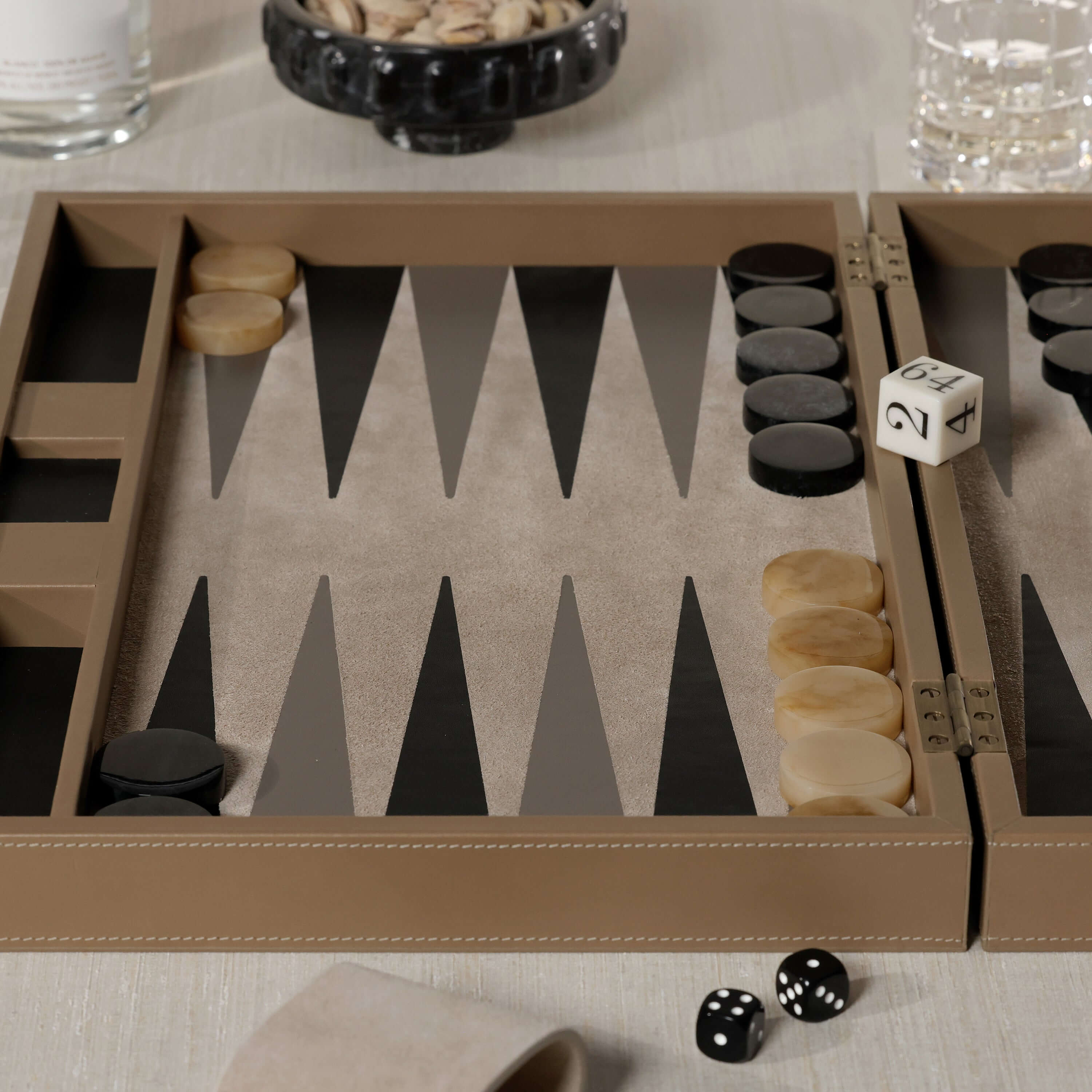 Geneva 19" Backgammon Set - Taupe Leather with game pieces and dice on a stylish table.